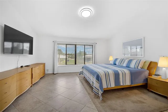 a spacious bedroom with a bed and window