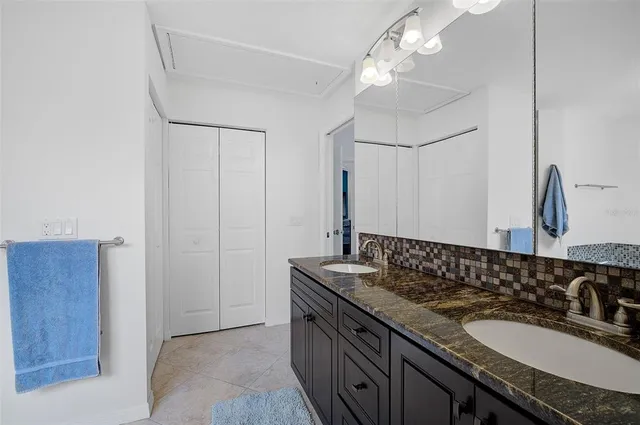 a bathroom with a granite countertop sink a mirror and vanity