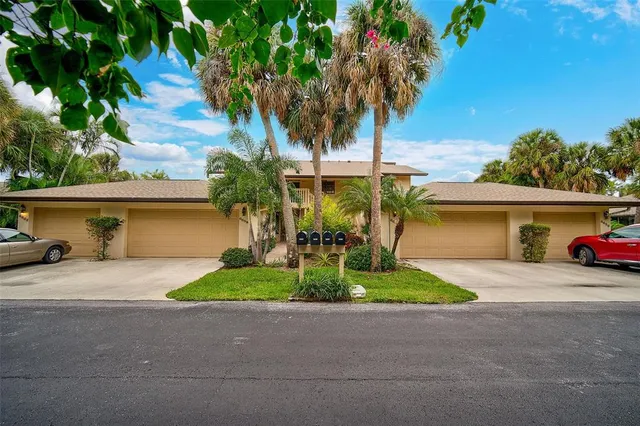 a view of a house with outdoor space and palm trees