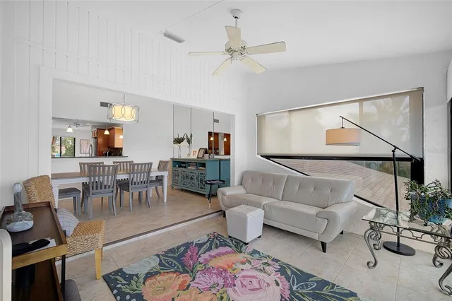 a living room with furniture and a painting on the wall