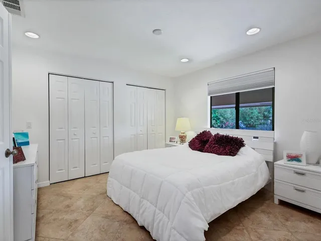 a bedroom with a large bed and a window