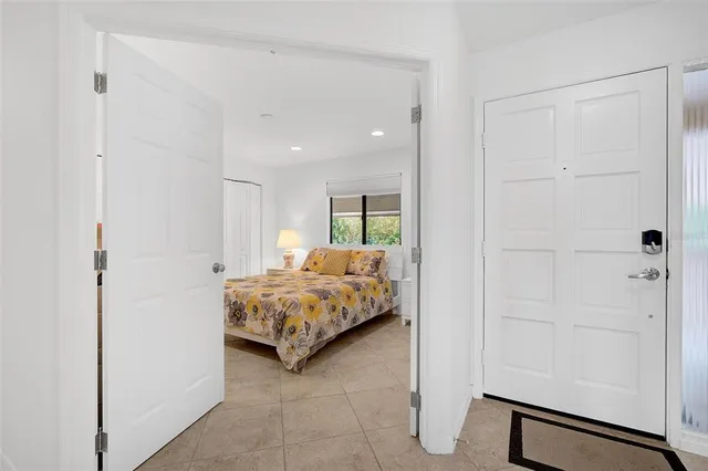 a bedroom with a bed and a walk in closet with bathroom