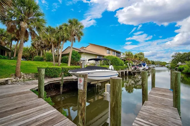 a patio with hardwood chairs and lake view