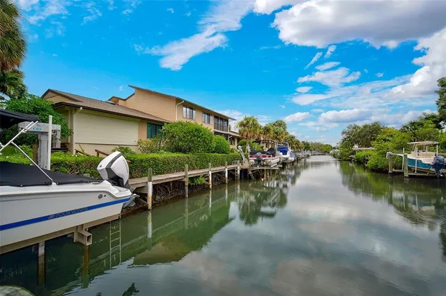 a view of house with yard outdoor seating and lake view