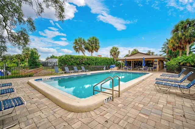a view of a swimming pool with lounge chair