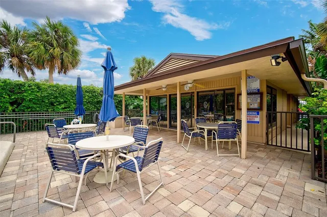 a view of a patio with a dining table and chairs