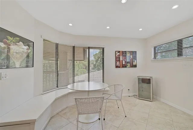 a living room with furniture and large windows