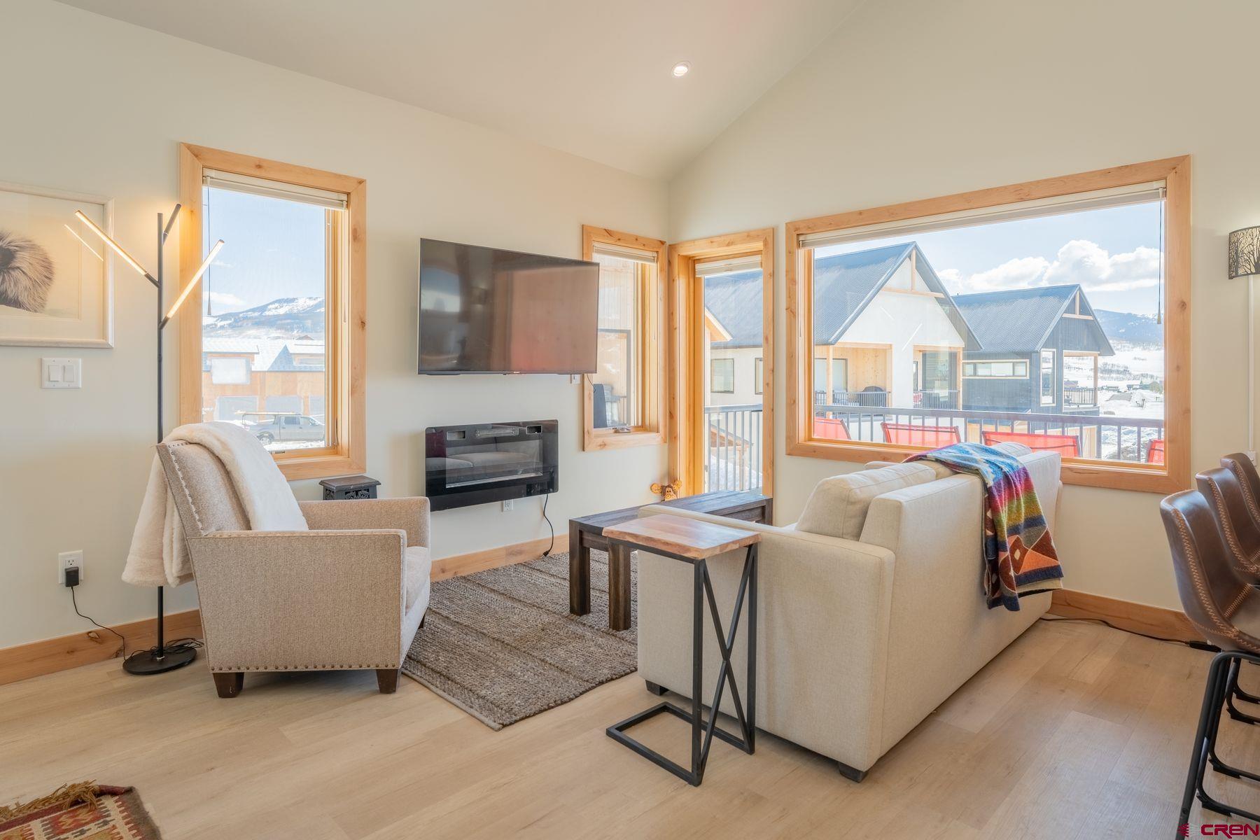 231 Elk Valley Road, Unit 2D Crested Butte, CO 81224 - Photo 11 of 35 a living room with furniture and a large window
