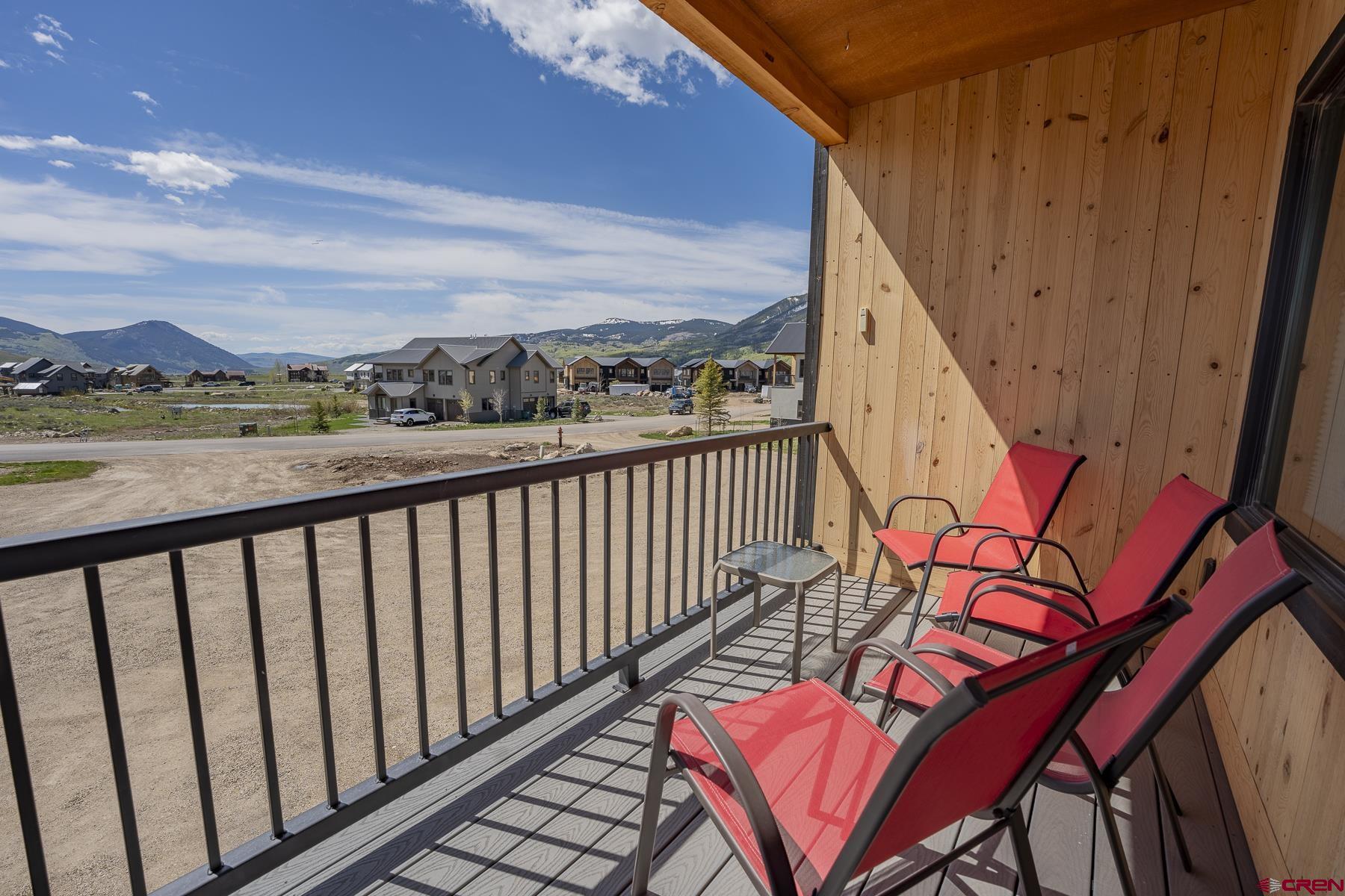 231 Elk Valley Road, Unit 2D Crested Butte, CO 81224 - Photo 12 of 35 a balcony with wooden floor and city view