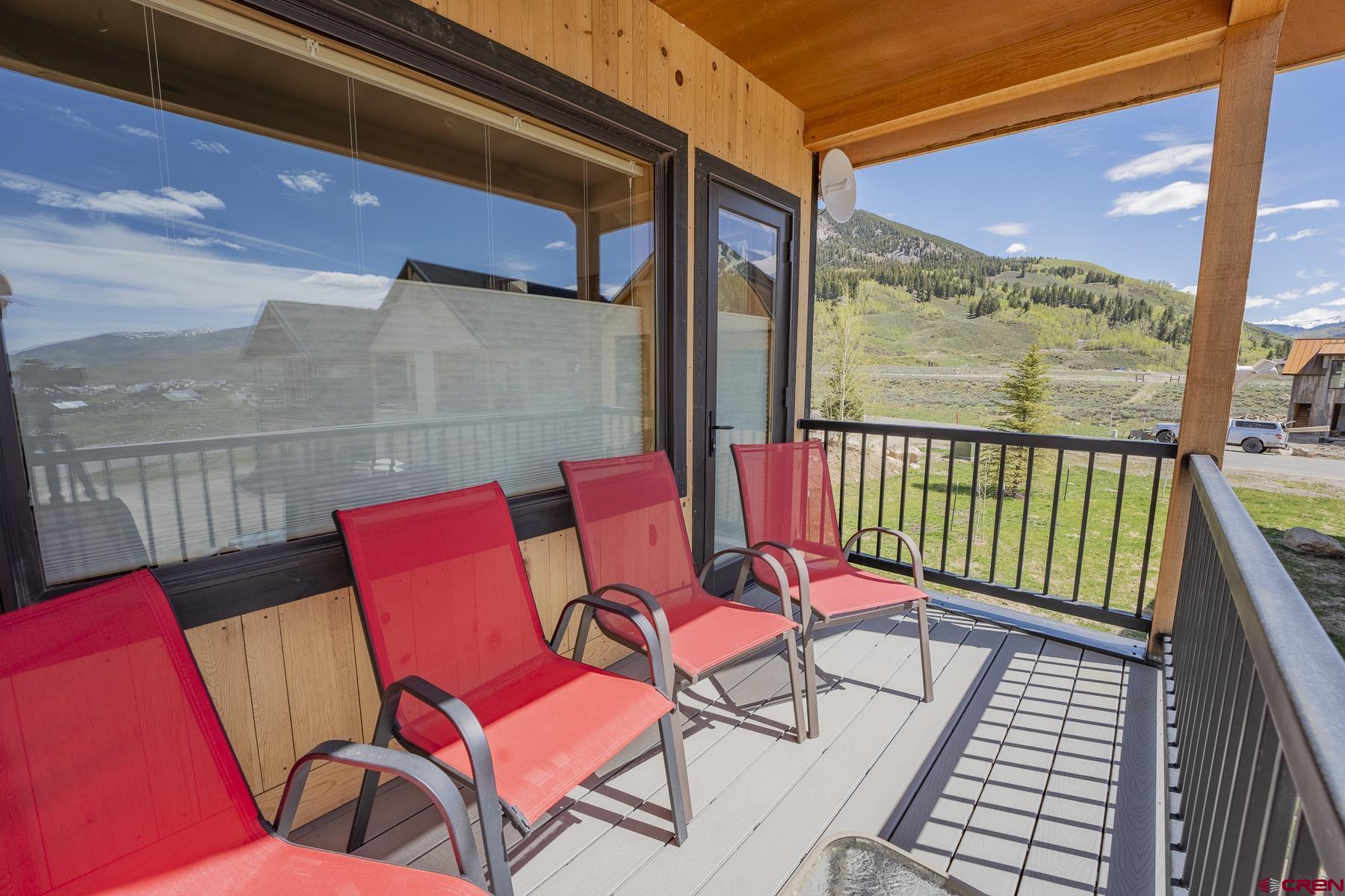 231 Elk Valley Road, Unit 2D Crested Butte, CO 81224 - Photo 13 of 35 a balcony with chairs and wooden floor