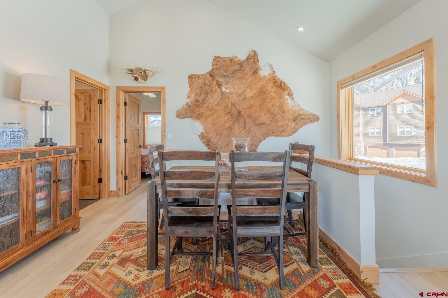 231 Elk Valley Road, Unit 2D Crested Butte, CO 81224 - Photo 15 of 35 a view of a dining room with furniture window and wooden floor