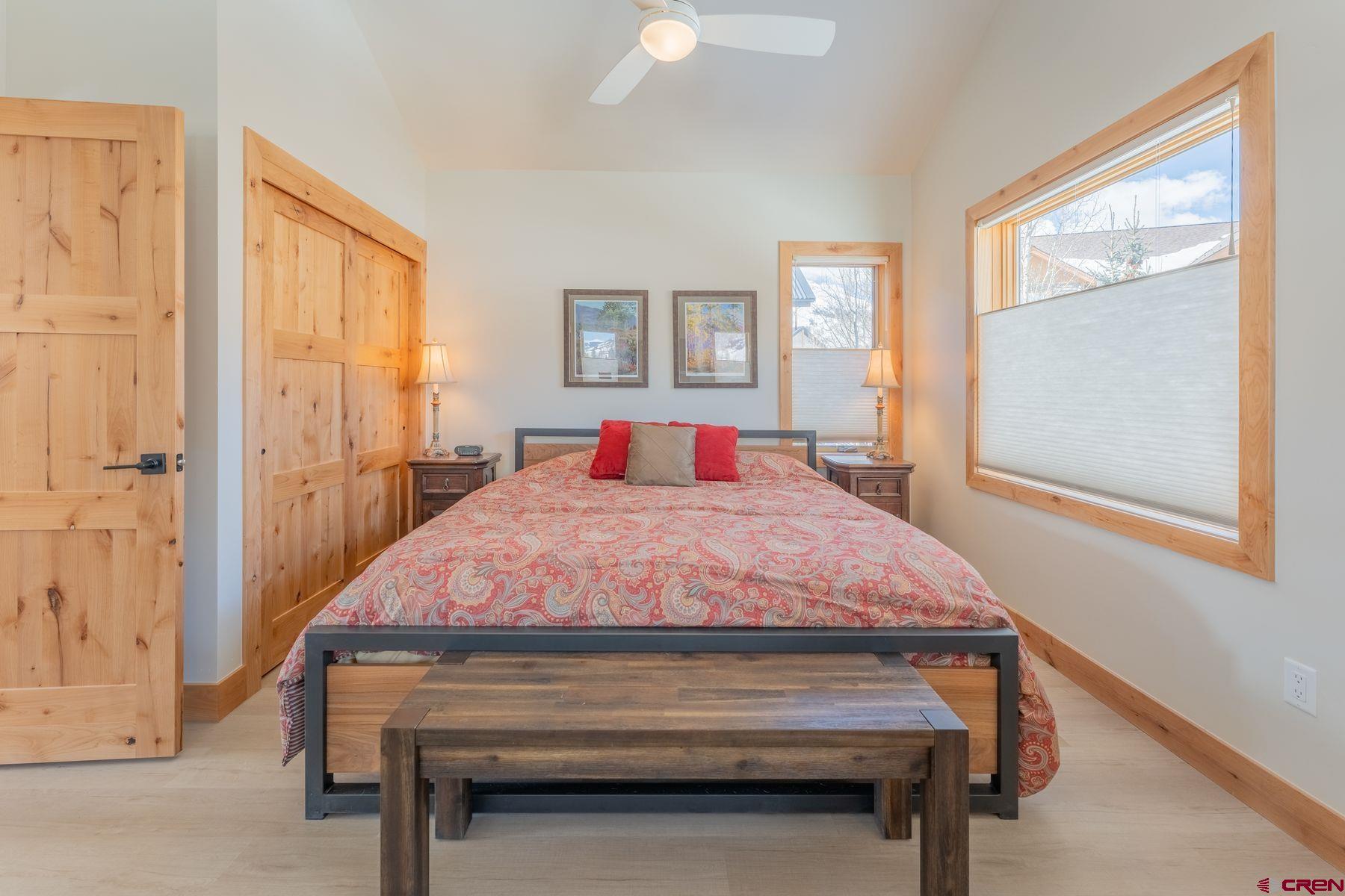 231 Elk Valley Road, Unit 2D Crested Butte, CO 81224 - Photo 18 of 35 a bedroom with a bed and window