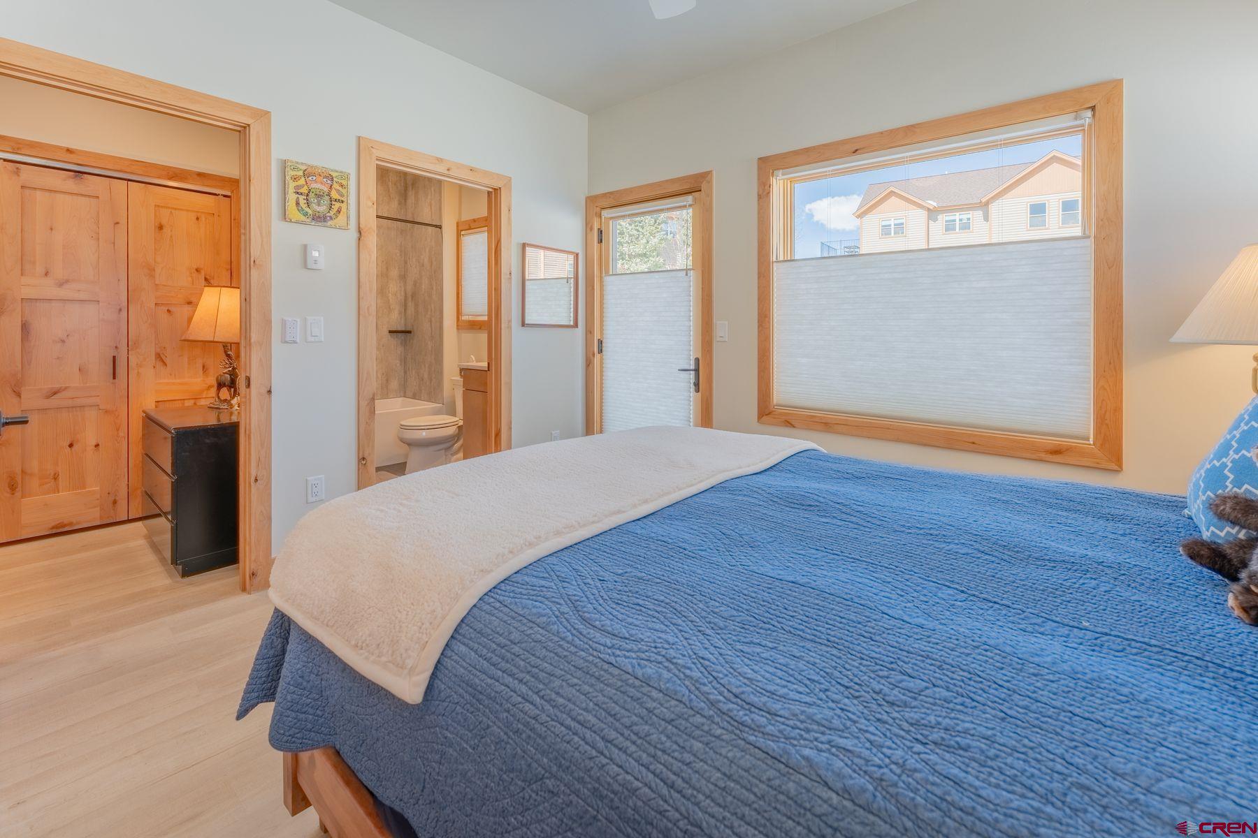 231 Elk Valley Road, Unit 2D Crested Butte, CO 81224 - Photo 23 of 35 a bedroom with a bed and a dresser next to a window