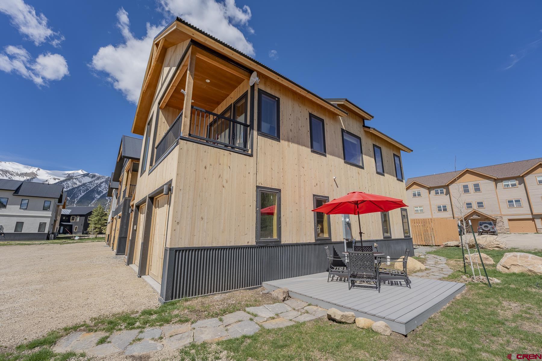 231 Elk Valley Road, Unit 2D Crested Butte, CO 81224 - Photo 26 of 35 a view of a house with backyard and sitting area