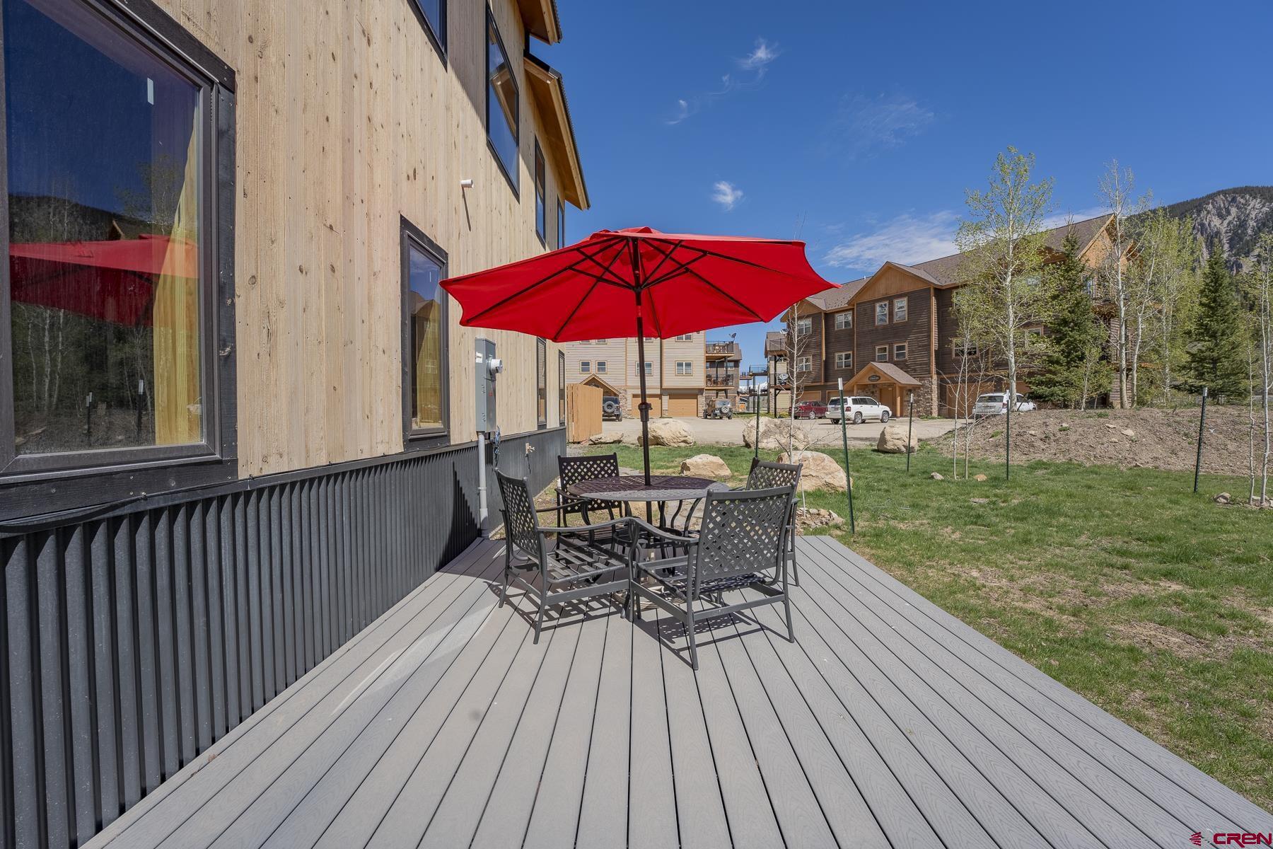 231 Elk Valley Road, Unit 2D Crested Butte, CO 81224 - Photo 27 of 35 a view of a patio with a table chairs and backyard