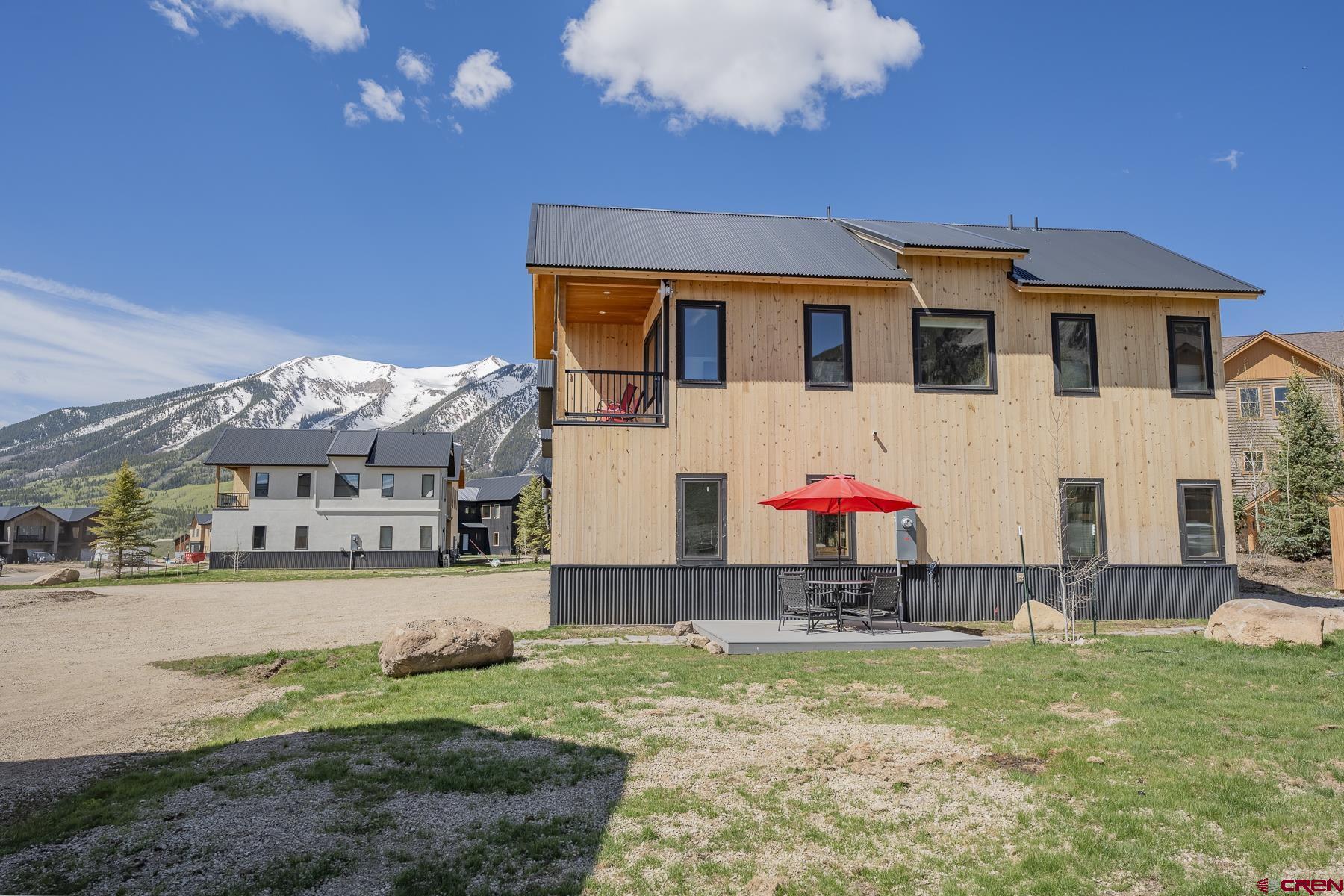 231 Elk Valley Road, Unit 2D Crested Butte, CO 81224 - Photo 28 of 35 a view of a house with a backyard