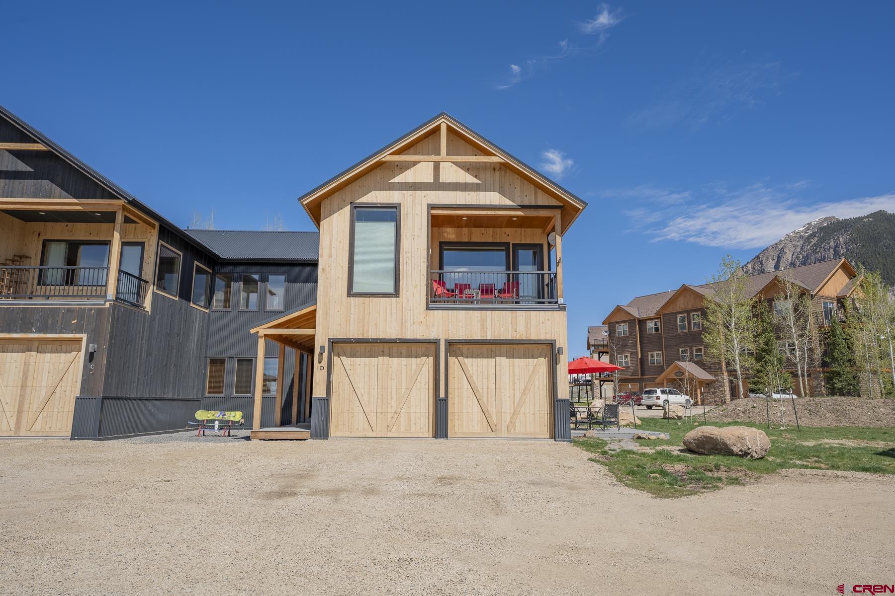 231 Elk Valley Road, Unit 2D Crested Butte, CO 81224 - Photo 29 of 35 a front view of a house with a yard
