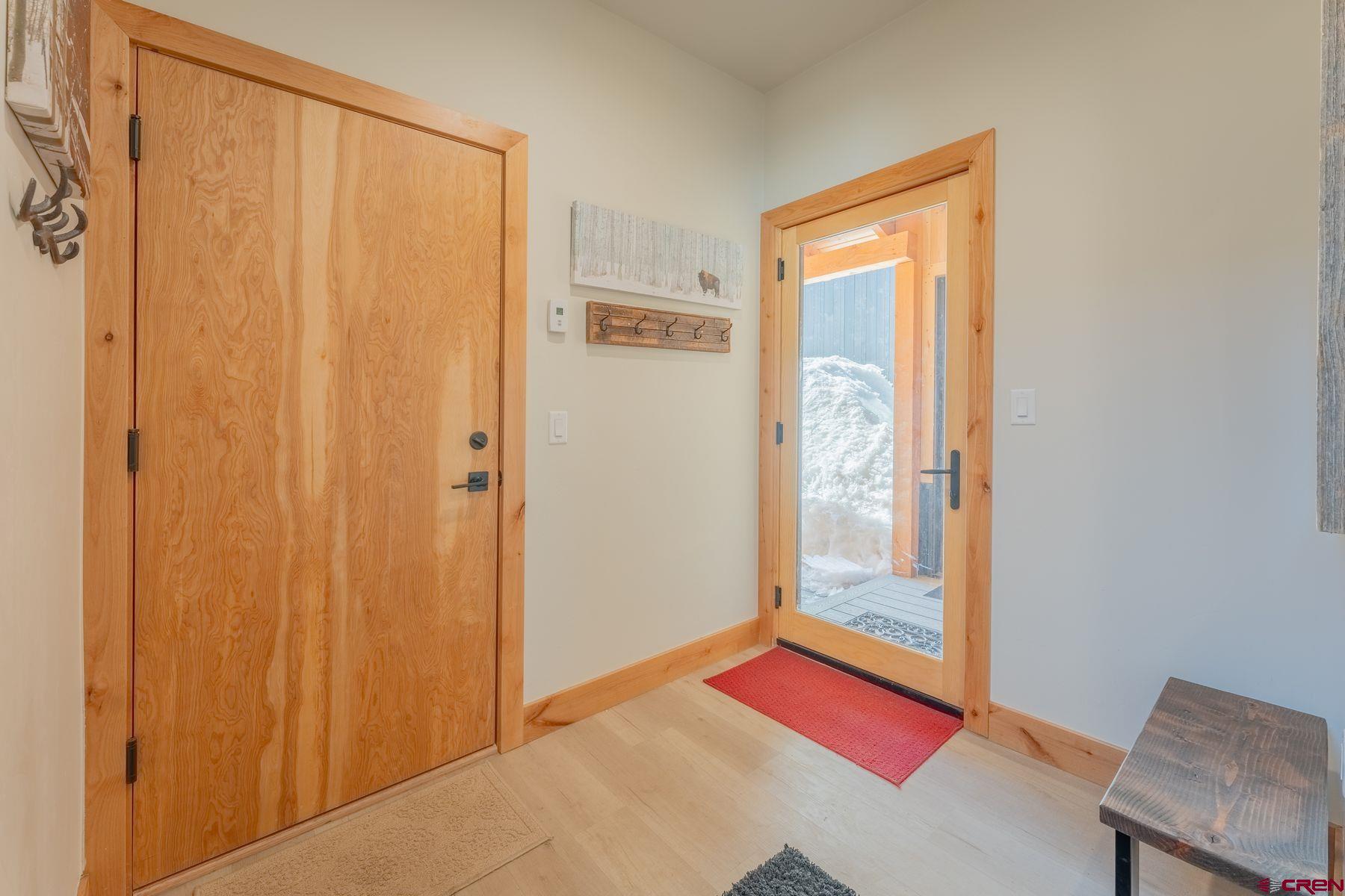 231 Elk Valley Road, Unit 2D Crested Butte, CO 81224 - Photo 4 of 35 a bedroom with a bed and a window