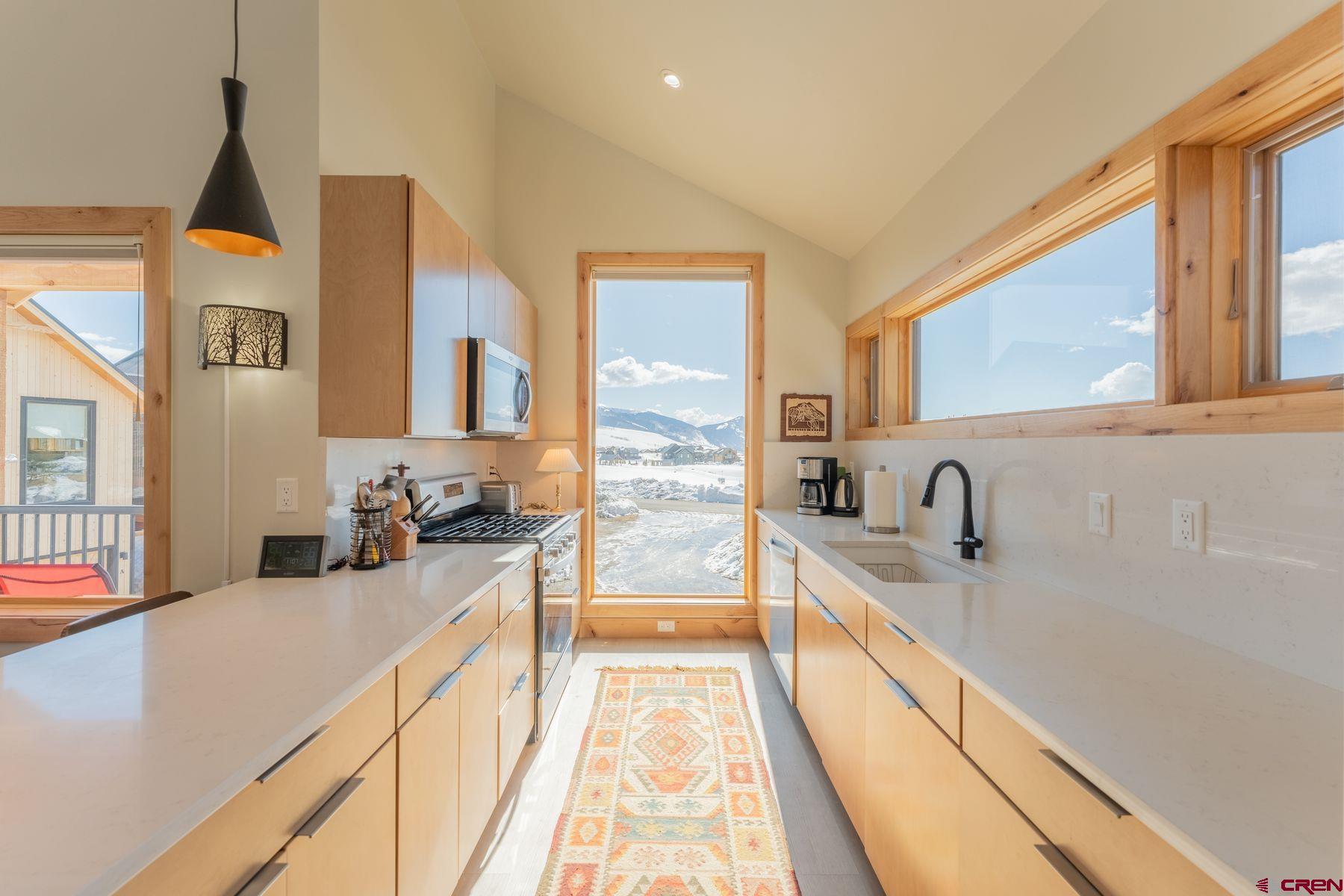231 Elk Valley Road, Unit 2D Crested Butte, CO 81224 - Photo 9 of 35 a view of a kitchen with a sink and wooden floor
