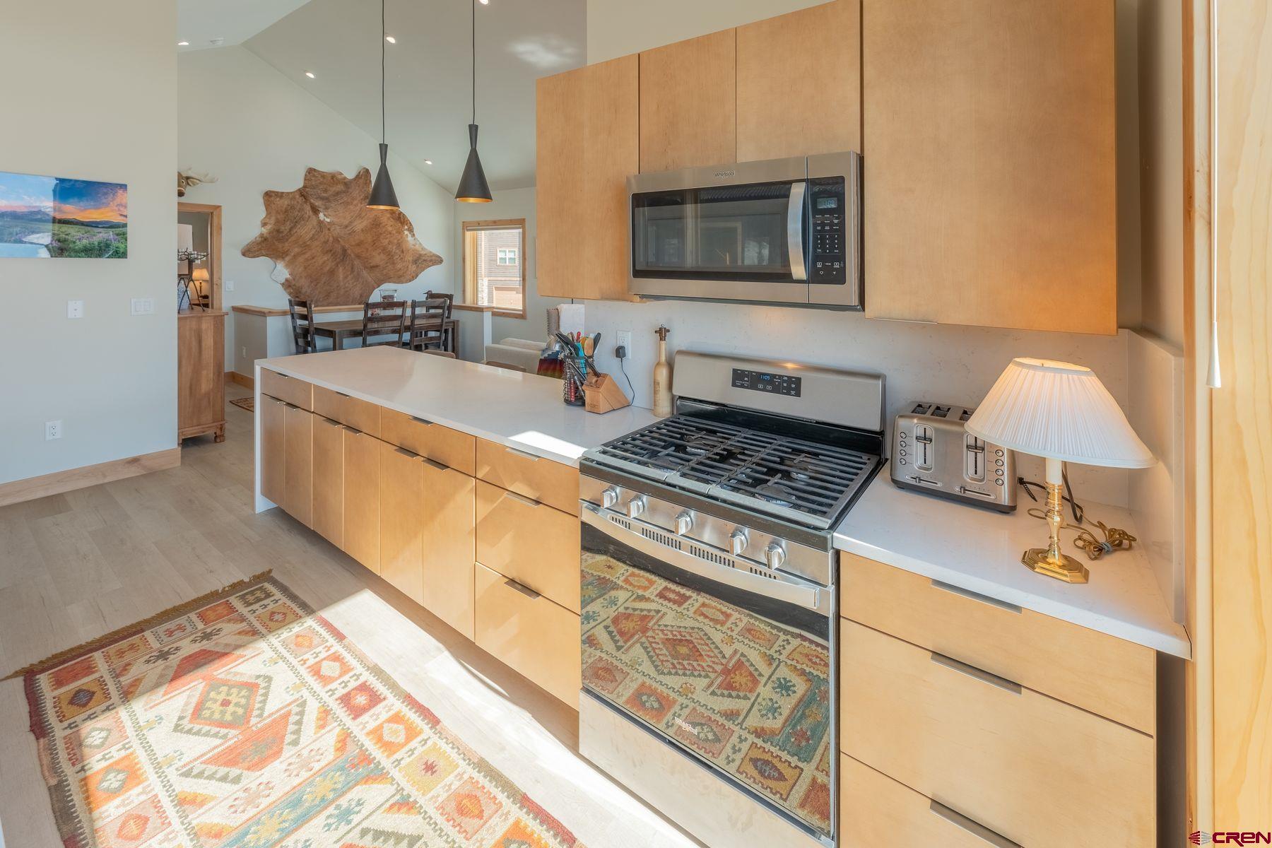 231 Elk Valley Road, Unit 2D Crested Butte, CO 81224 - Photo 10 of 35 a kitchen with stainless steel appliances granite countertop a sink stove and microwave