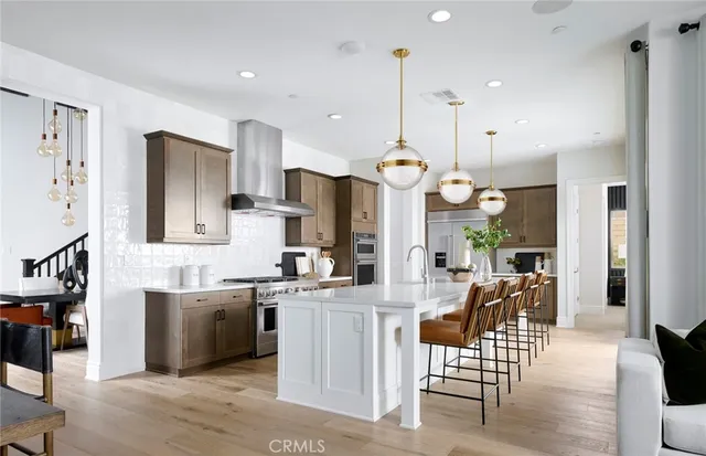 a large kitchen with a table and chairs