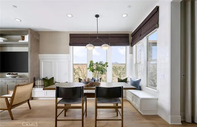a living room with furniture a large window and a flat screen tv