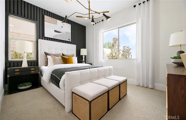 a bedroom with a bed a window and couch