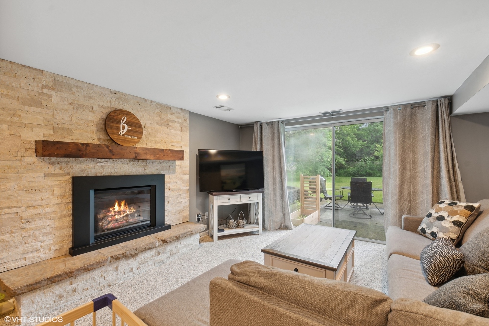 580 East Old Elm Road Lake Forest, IL 60045 - Photo 17 of 23 a living room with furniture a fireplace and a flat screen tv