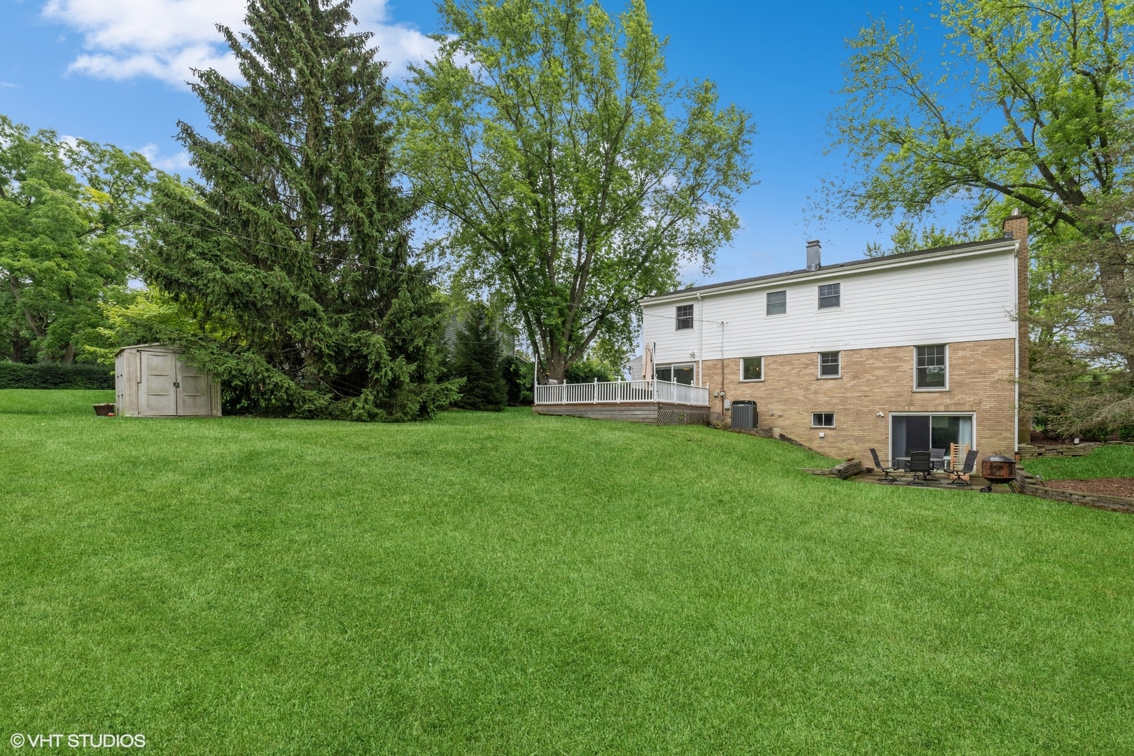 580 East Old Elm Road Lake Forest, IL 60045 - Photo 18 of 23 a view of a white house with a big yard and large trees