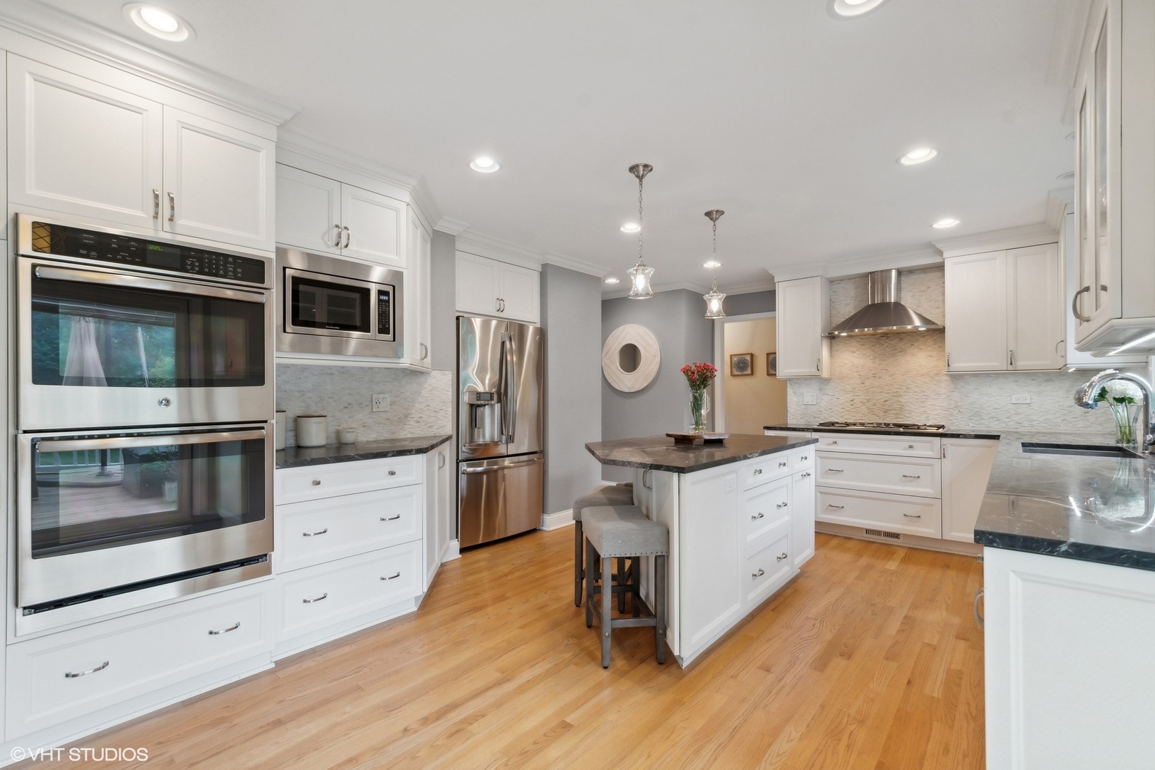 580 East Old Elm Road Lake Forest, IL 60045 - Photo 3 of 23 a large kitchen with stainless steel appliances kitchen island granite countertop a stove a sink and a microwave