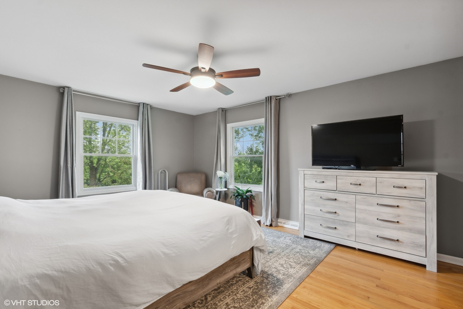 580 East Old Elm Road Lake Forest, IL 60045 - Photo 10 of 23 a bedroom with a large bed a flat tv screen and large windows