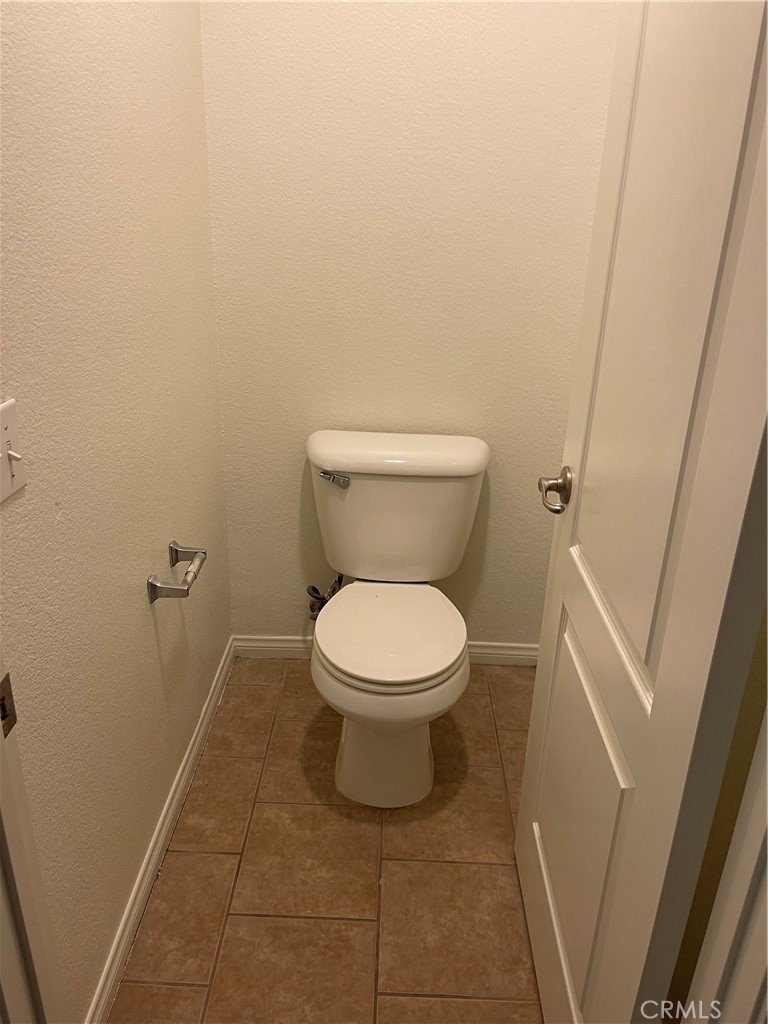 4438 Leonard Court Riverside, CA 92501 - Photo 19 of 36 a white toilet sitting next to a white sink