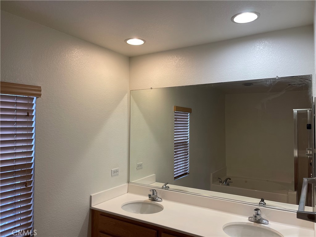 4438 Leonard Court Riverside, CA 92501 - Photo 20 of 36 a bathroom with a sink and a mirror