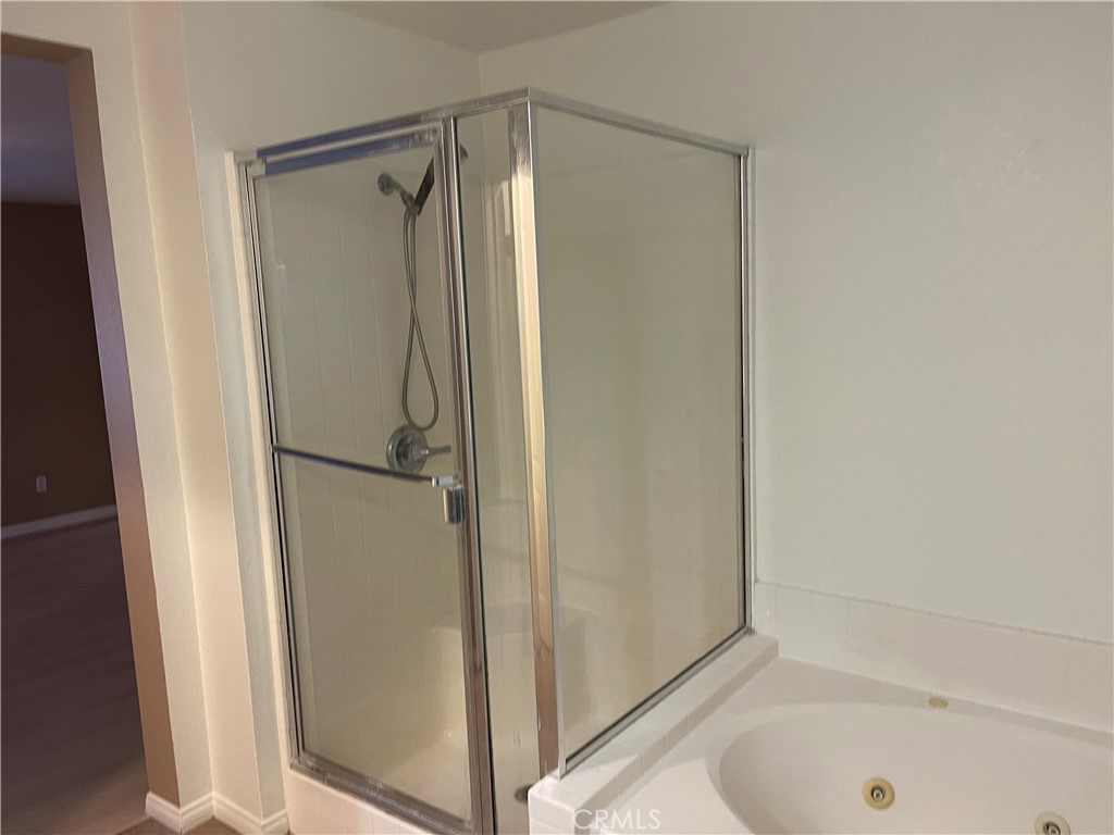 4438 Leonard Court Riverside, CA 92501 - Photo 24 of 36 a bathroom with a bathtub and a shower