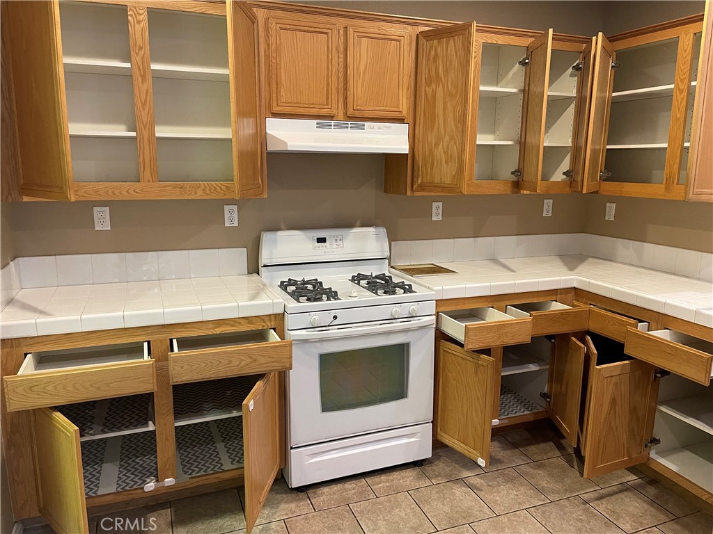 4438 Leonard Court Riverside, CA 92501 - Photo 30 of 36 a kitchen with a stove and a sink