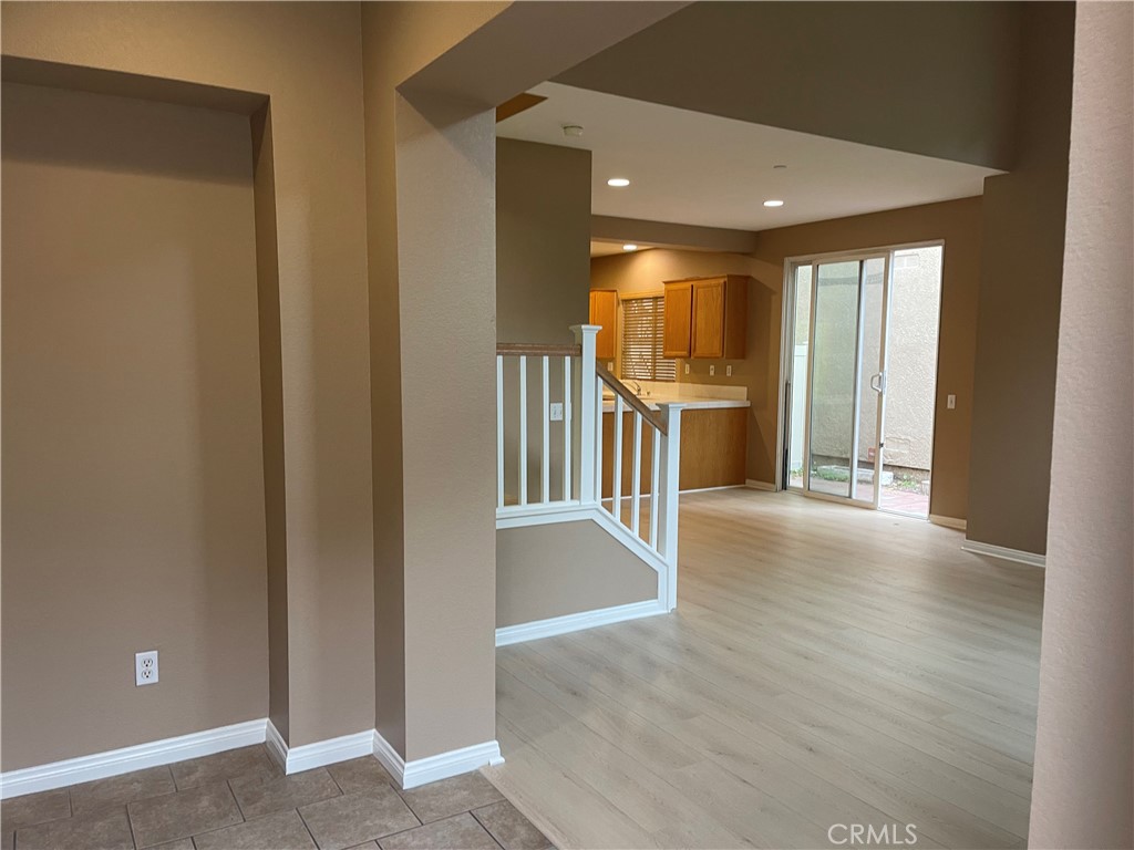 4438 Leonard Court Riverside, CA 92501 - Photo 3 of 36 a view of a hallway with wooden floor and fireplace