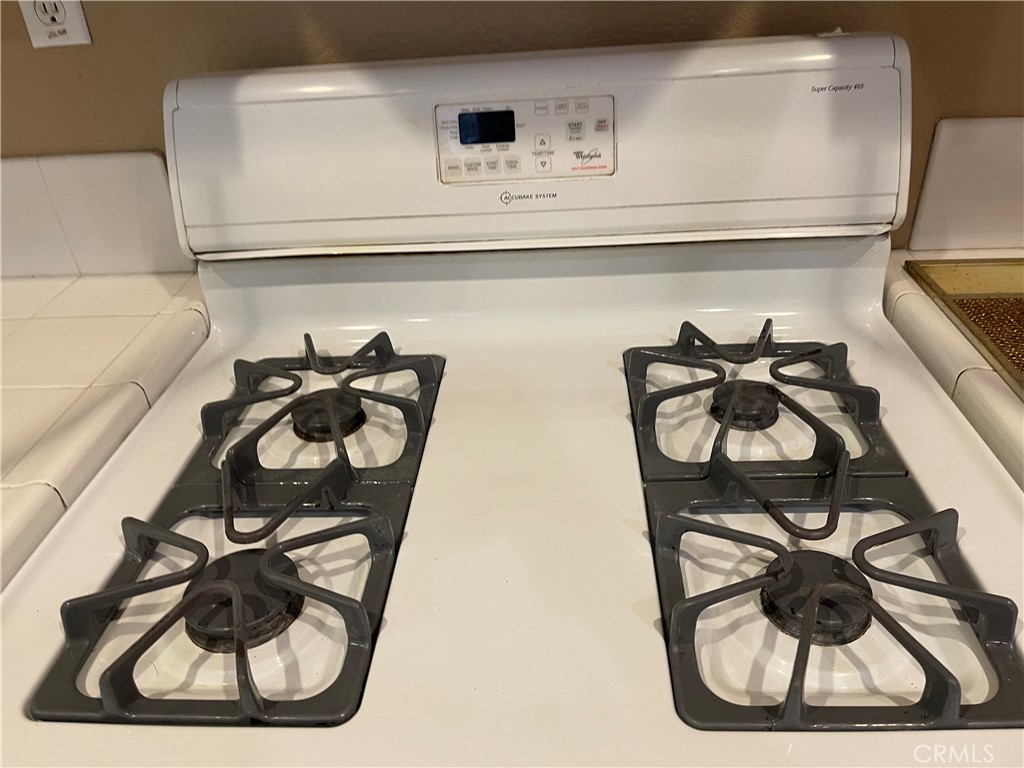 4438 Leonard Court Riverside, CA 92501 - Photo 33 of 36 a white cabinet with a vase and on it