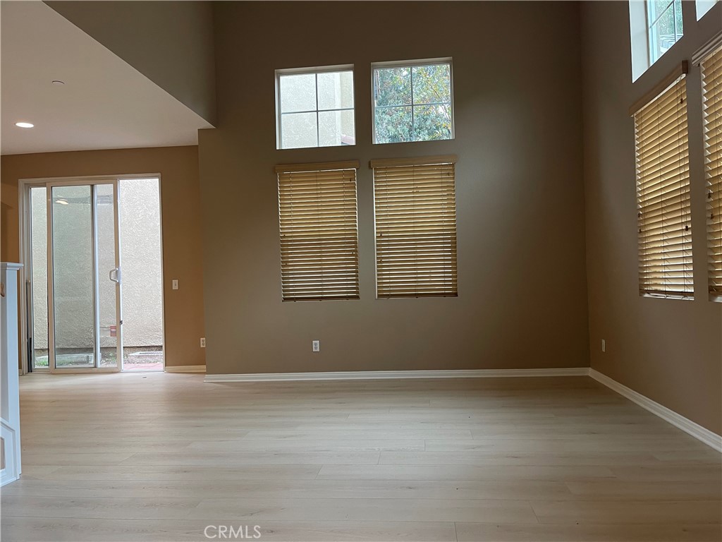 4438 Leonard Court Riverside, CA 92501 - Photo 4 of 36 an empty room with wooden floor and windows