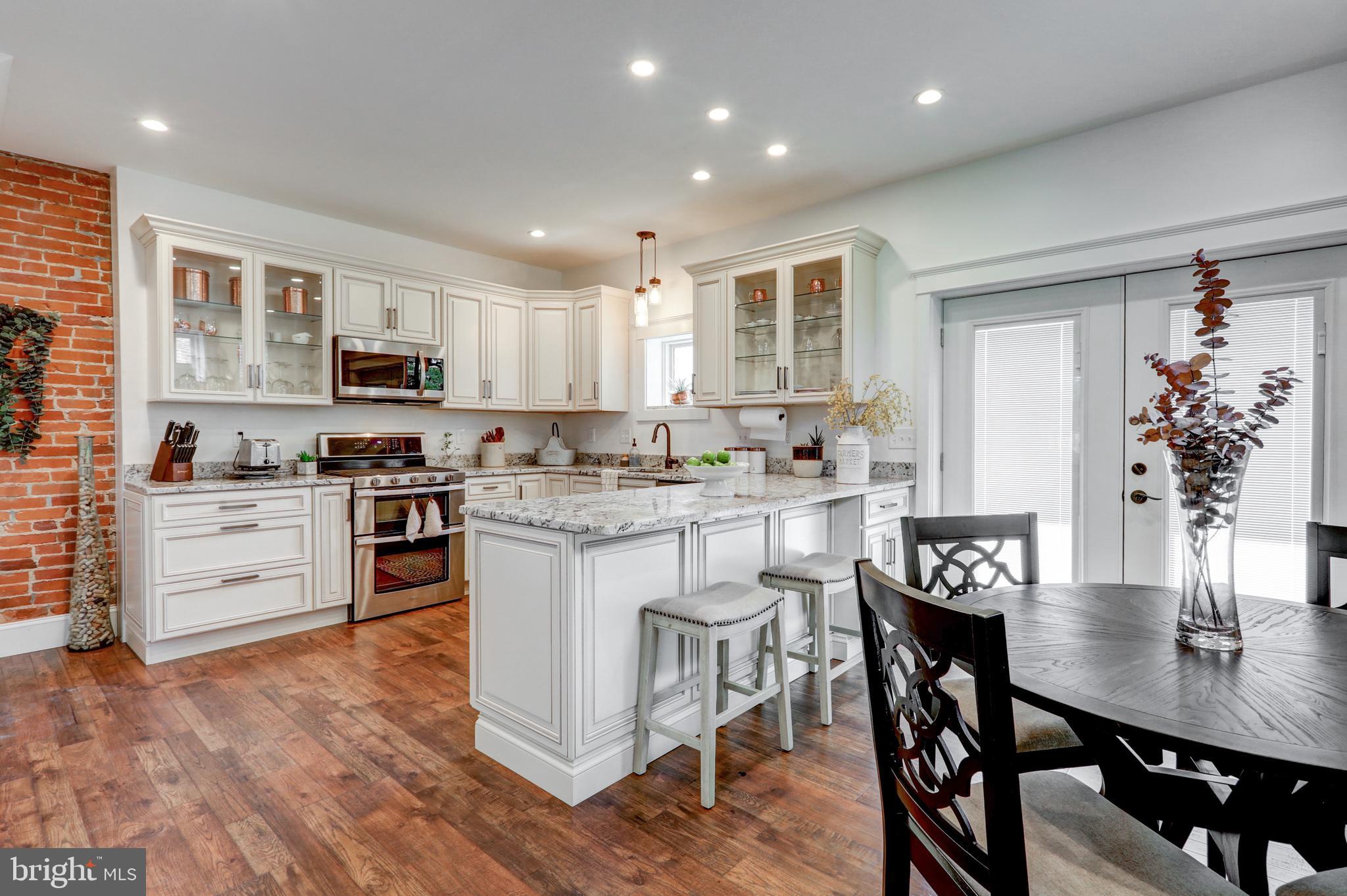 354 New Holland Avenue Lancaster, PA 17602 - Photo 2 of 43 a kitchen with a dining table chairs and refrigerator