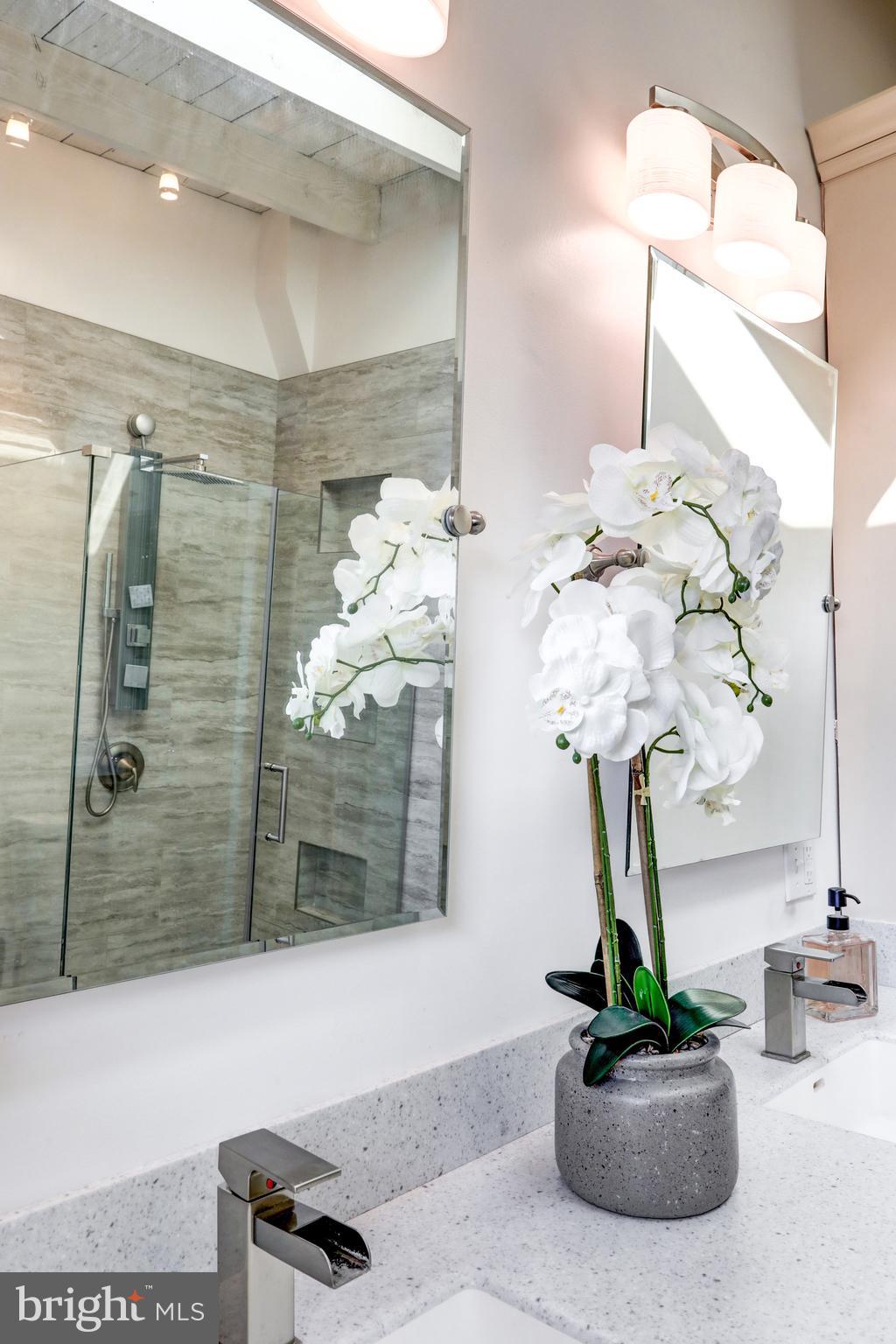 354 New Holland Avenue Lancaster, PA 17602 - Photo 24 of 43 a vase of flowers sitting on a bathroom table