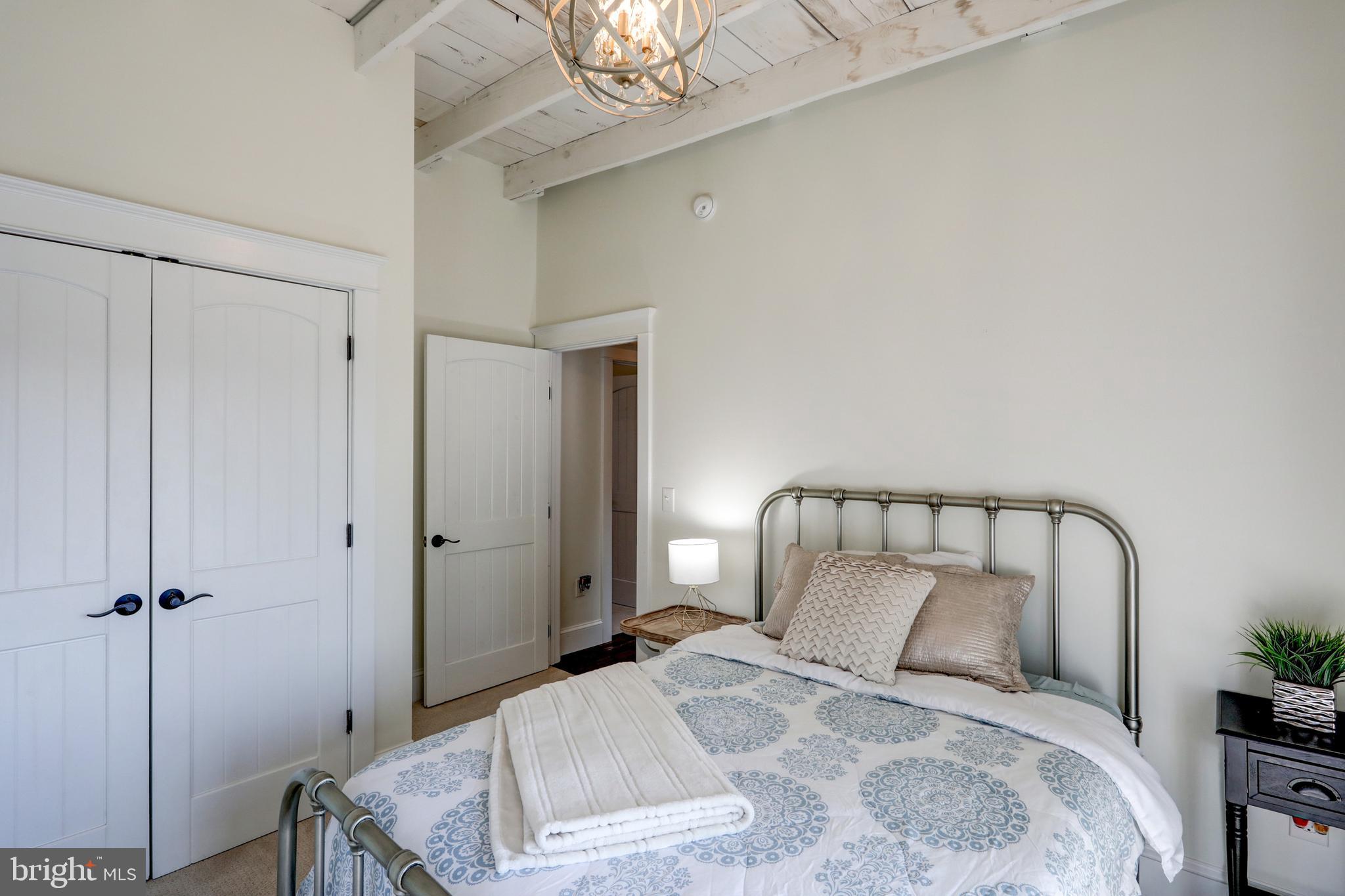 354 New Holland Avenue Lancaster, PA 17602 - Photo 30 of 43 a bedroom with a bed and a potted plant on the dresser