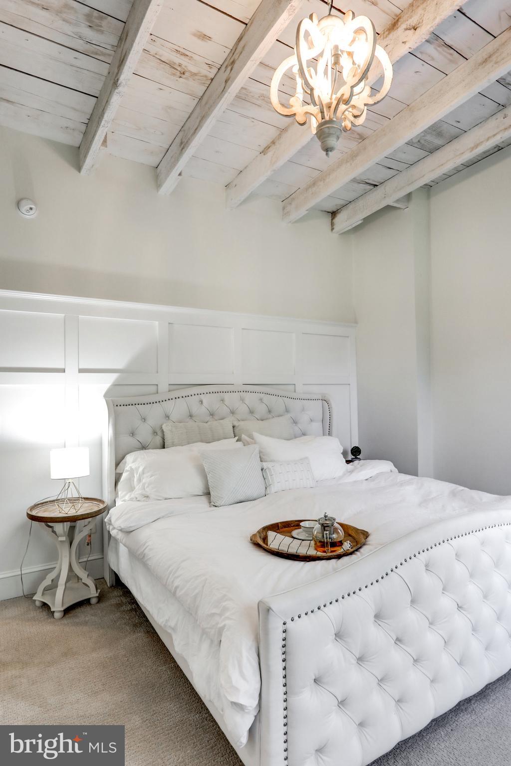 354 New Holland Avenue Lancaster, PA 17602 - Photo 32 of 43 a bedroom with a bed a chandelier and a lamp on the dresser