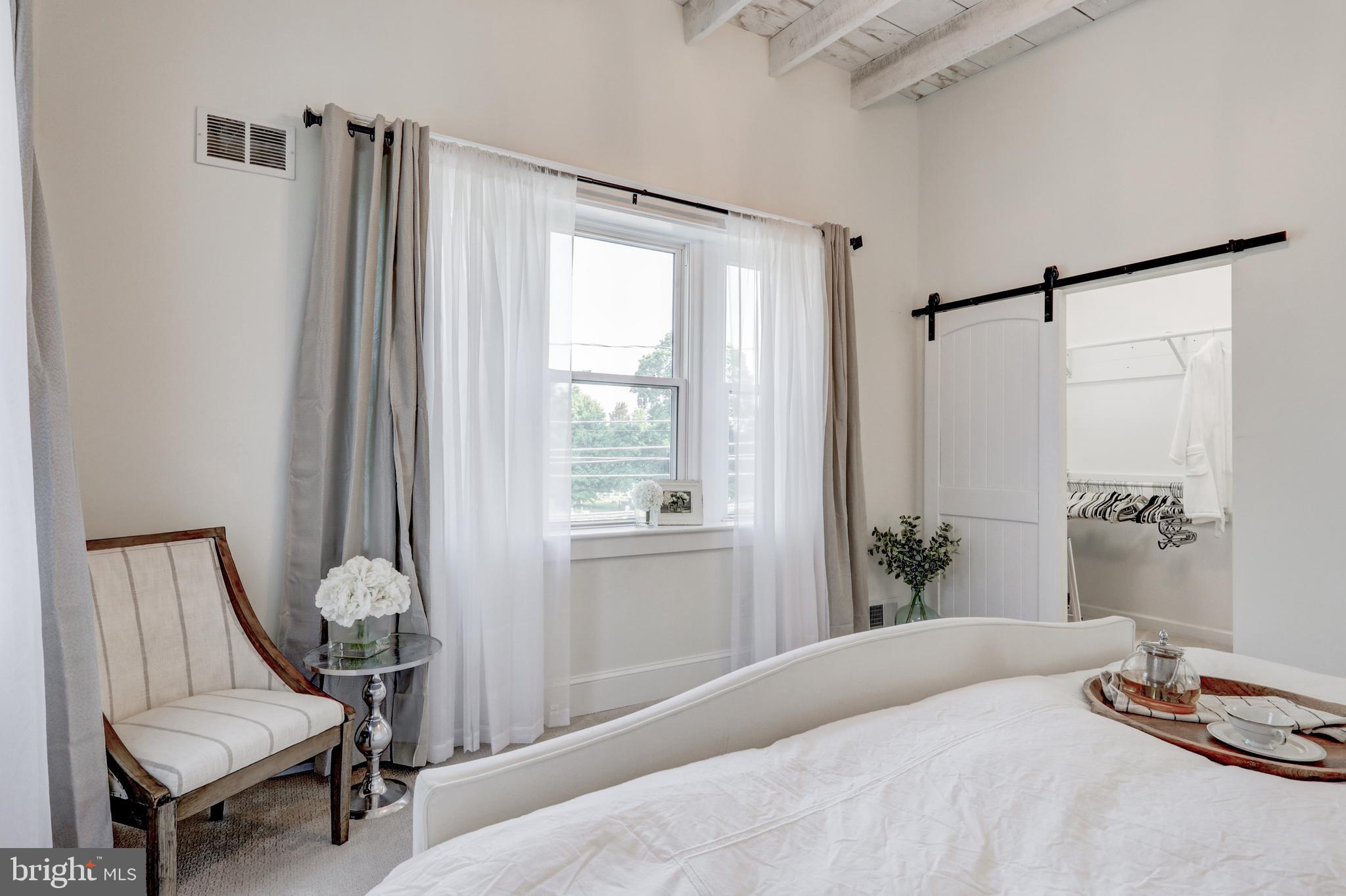 354 New Holland Avenue Lancaster, PA 17602 - Photo 34 of 43 a bedroom with a bed and a chair