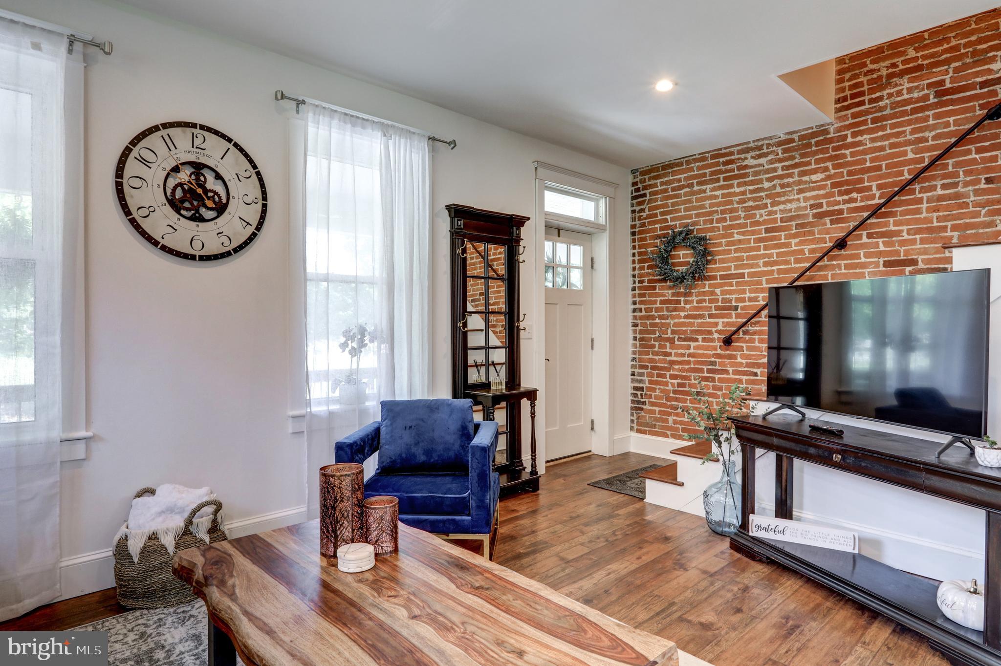 354 New Holland Avenue Lancaster, PA 17602 - Photo 6 of 43 a living room with furniture a flat screen tv and a wall clock