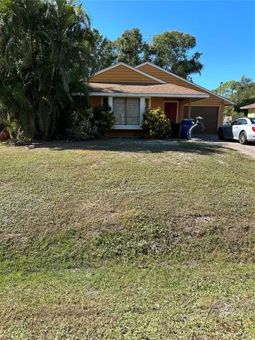 a front view of a house with yard and green space