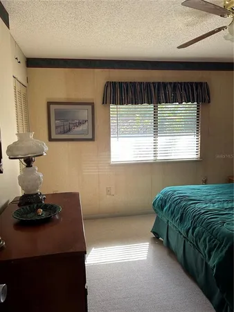 a bedroom with a bed and windows