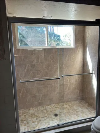 a bathroom with a glass shower door