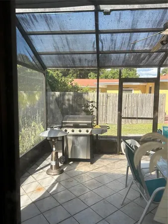 a living room with a large window and furniture