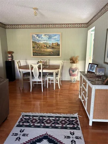 a living room with dining room and wooden floor