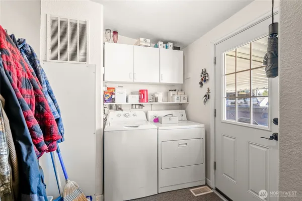 a dining room with stainless steel appliances kitchen island granite countertop a dining table and chairs with wooden floor